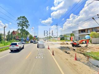 Street view of a developing area with vehicles and construction equipment