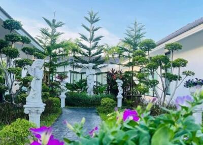 Beautiful garden with statues and topiary trees