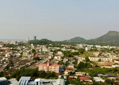 Aerial view of residential and commercial area with surrounding hills