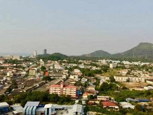 Aerial view of residential and commercial area with surrounding hills