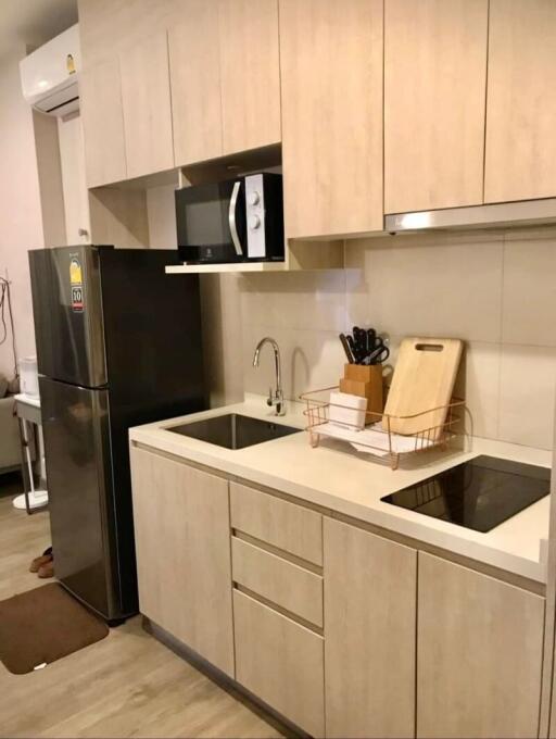 Modern kitchen with built-in appliances, sink, and storage cabinets