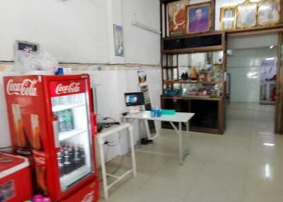 Miscellaneous interior with a Coca-Cola fridge, table, and shelving unit