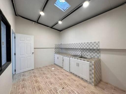 Modern kitchen with checkered backsplash and skylight