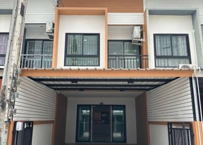 Front view of a modern townhouse with garage