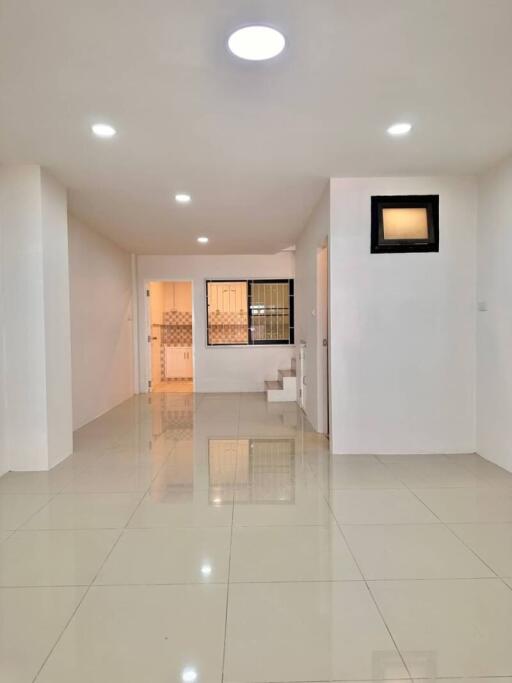 Spacious and well-lit living area with tiled flooring