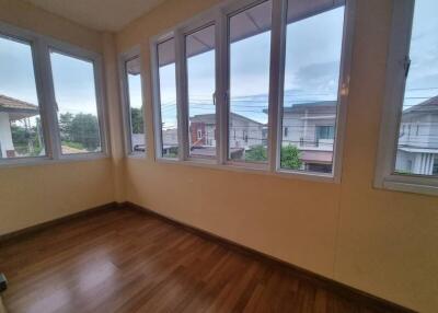 Room with large windows and a wooden floor