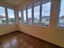 Room with large windows and a wooden floor