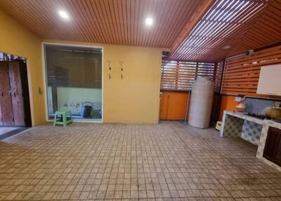 Spacious patio area with tiled floor and wooden ceiling