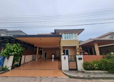 Front view of a modern house with carport and front yard