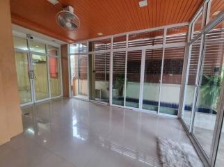 Spacious glass-enclosed living area with tiled flooring