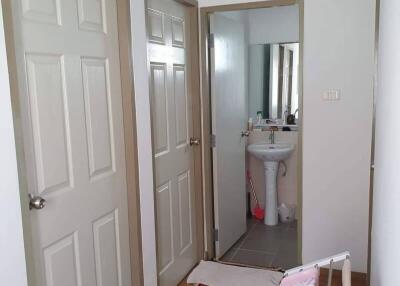 Hallway with doors leading to bathroom and rooms