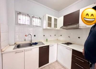 Modern kitchen with white cabinets and stainless steel appliances