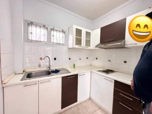 Modern kitchen with white cabinets and stainless steel appliances