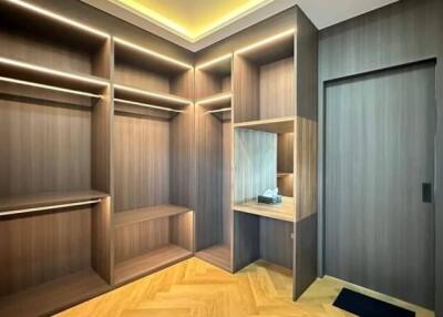 Spacious custom-built walk-in closet with integrated lighting