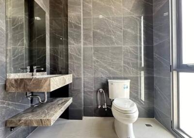 Modern bathroom with large tiles and a floating vanity