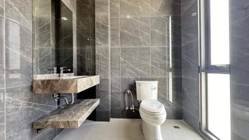 Modern bathroom with large tiles and a floating vanity