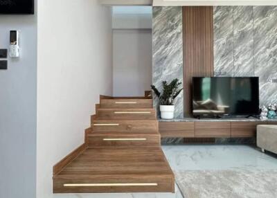 Modern living room with staircase and TV