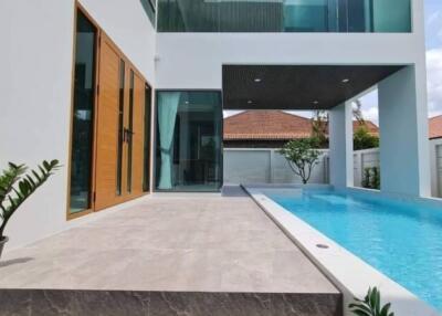 Modern house with glass features and a swimming pool