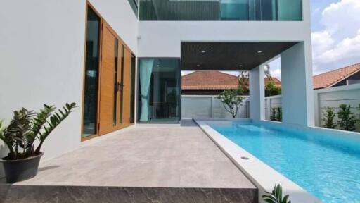 Modern house with glass features and a swimming pool