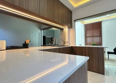 Modern kitchen with wooden cabinetry and white countertops