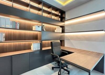 Modern home office with built-in shelves and desk