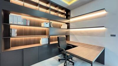 Modern home office with built-in shelves and desk