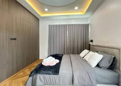 Modern bedroom with gray accents and recessed lighting