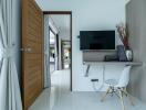 Modern bedroom with wall-mounted TV and a minimalist desk