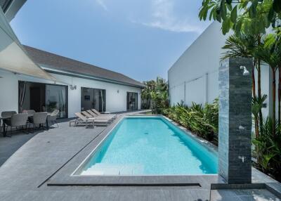 Outdoor area with swimming pool and lounging chairs