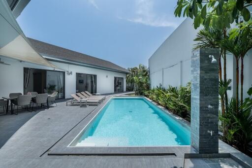 Outdoor area with swimming pool and lounging chairs