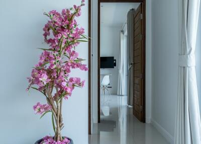 Well-lit hallway with decorative plant