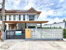 Modern two-story house with a gated front yard