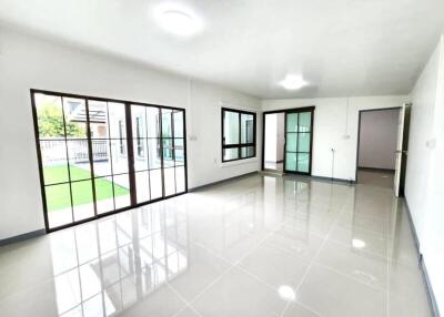 Spacious and brightly lit living area with large windows and sliding doors