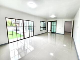 Spacious and brightly lit living area with large windows and sliding doors