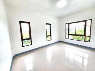 Bright and spacious empty bedroom with large windows