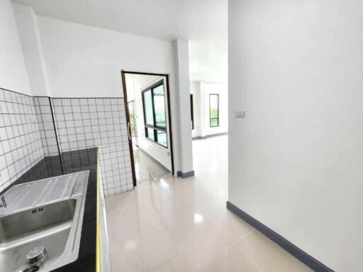 Modern kitchen with tiled backsplash and stainless steel sink