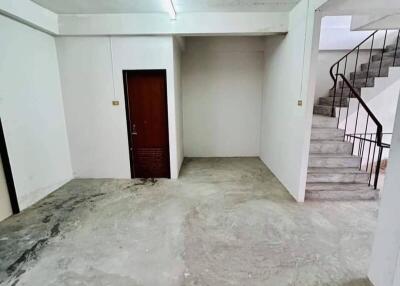 Empty room with concrete floor and stairway