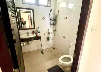 Bathroom with a shower, toilet, and sink