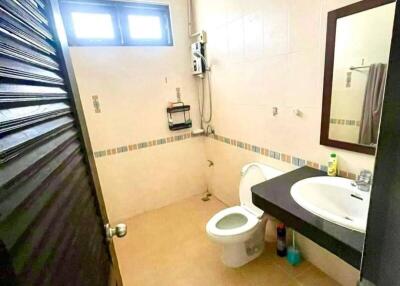 Bathroom with toilet, sink, and mirror