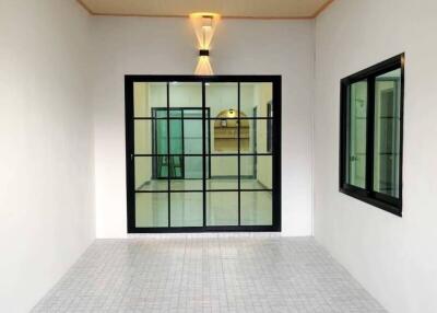 Enclosed lighted space with tiled floor and glass door