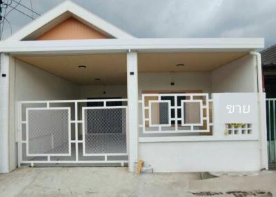 Front view of a residential house with a gated entrance