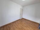 Empty bedroom with wooden flooring and white walls