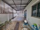 Covered patio with gravel and tiled floor area