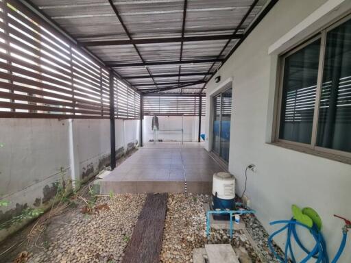 Covered patio with gravel and tiled floor area