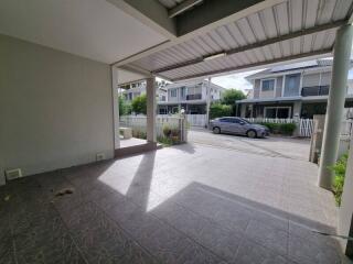 Covered garage with driveway and street view