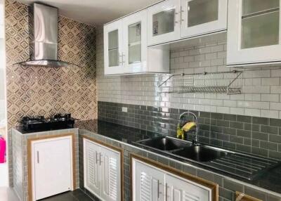 Modern kitchen with tiled backsplash and stainless steel sink