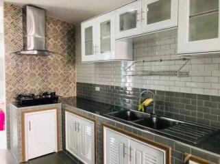 Modern kitchen with tiled backsplash and stainless steel sink