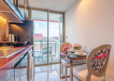 Modern kitchen with dining area and balcony view