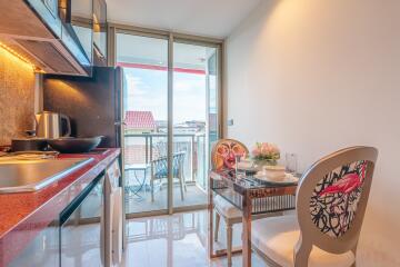 Modern kitchen with dining area and balcony view