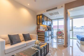 Modern open living and dining area with balcony view